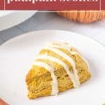 A single pumpkin scone with white icing sits on a white plate. In the background, a pumpkin accompanies the text "Tender pumpkin scones.