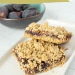 A plate with two fig bars is shown in the foreground, while a bowl of whole figs is in the background. Text reads "fresh fig bars" and "get the recipe, www.stetted.com.