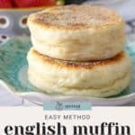 Two freshly baked English muffins rest invitingly on a teal plate, with vibrant strawberries offering a sweet contrast in the background. Text reads: "Easy Method English Muffin Recipe.