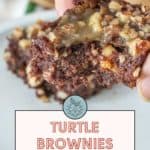 Close-up of a hand holding turtle brownies with nuts on top. Text on the image reads: "Turtle Brownies - rich & nutty. Get the recipe at stetted.com.