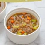 Two bowls of hearty beef bulgur soup with tender chunks of beef, carrots, celery, and wholesome bulgur in a savory broth. Text overlay reads "beef bulgur soup" and "easy recipe" with a website URL below.