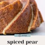 Close-up of a spiced pear cake decadently drizzled with salted caramel sauce.