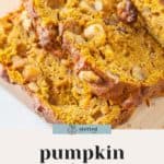 Close-up of sliced pumpkin persimmon bread with visible nuts, resting on a light-colored surface. The text "pumpkin persimmon bread" is displayed below the image, highlighting this delectable seasonal treat.