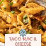 Close-up of taco mac and cheese, featuring pasta shells mixed with ground meat, gooey cheese, and garnished with green onions. Text overlay reads, "Taco Mac & Cheese - family favorite" with a website link for the recipe.