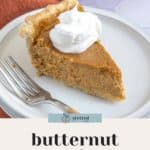 A slice of luscious butternut squash pie topped with whipped cream sits invitingly on a white plate with a fork. The pie boasts a perfectly flaky crust.