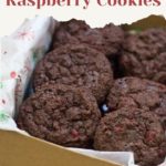 A box of delightful chocolate raspberry cookies rests on festive paper, adorned with the words: "The Best Ever Chocolate Raspberry Cookies. Get the recipe at stetted.com".