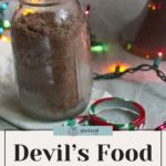 A jar of Devil’s Food Cake Mix sits on the table, surrounded by colorful string lights. The text reads, "Devil's Food Cake Mix: Easy Homemade Recipe for delicious moments.