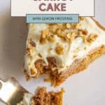 A delectable slice of carrot cake topped with zesty lemon frosting and a sprinkle of chopped nuts sits invitingly on a plate, with a fork gently holding an enticing piece of cake.