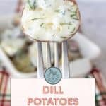 Close-up of a fork holding a dill potato with creamy topping over a background of similar potatoes. Text overlay reads: "Dill Potatoes. Easy side dish. Get the recipe at stetted.com.