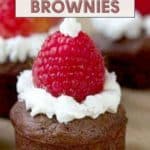 Close-up of Santa Hat Brownies adorned with white frosting and a raspberry, perfectly resembling a festive hat. Text reads "Santa Hat Brownies" and "Get the recipe at stetted.com.