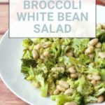 A plate of flavorful broccoli white bean salad sits invitingly on a wooden table, ready to tantalize your taste buds.