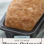 A loaf of honey oatmeal bread in a baking tin with a text overlay that reads "How to Make Honey Oatmeal Bread" and the website "stetted.com" displayed above the text. Perfect for pairing with grilled eggplant.