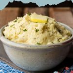 Bowl of creamy celery root mash topped with a pat of butter and herbs, showcasing the perfect homemade treat.