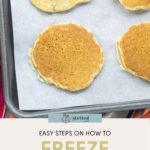 Four pancakes rest on a parchment-lined baking sheet, ready for freezing. Text reads: "Discover Easy Steps on How to Freeze Pancakes.