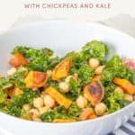 A bowl of roasted sweet potato salad with chickpeas and kale sits invitingly on a blue striped towel.