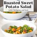 Two white bowls filled with a delicious roasted sweet potato salad, complete with chickpeas and kale, sit invitingly on a table with a striped napkin and fork.