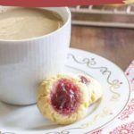 A cup of coffee sits beside two delicious raspberry thumbprint cookies on a decorative plate. Text reads "Raspberry Thumbprint Cookies" and "easy to make recipe, www.stetted.com." Perfect for a quick treat!