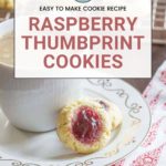 Cup of coffee on a saucer with a delectable raspberry thumbprint cookie. Text overlay reads "Easy to Make Cookie Recipe: Irresistible Raspberry Thumbprint Cookies".