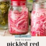 A glass jar of homemade pickled red onions stands among a colorful assortment of jars, with a text overlay: "Learn how to pickle your own red onions at home.