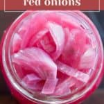 A jar brimming with vibrant, pickled red onions, viewed from above. Its label proudly declares "easy pickled red onions," inviting you to savor the tangy burst of flavor in every slice.