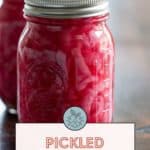 Two jars of mouthwatering pickled red onions stand proudly, each with a label that reads "Pickled Red Onions." A convenient website link accompanies them, revealing the secret recipe.