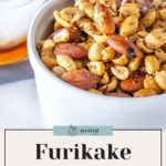 A bowl of furikake roasted nuts sits alongside a refreshing drink, embodying the perfect snack duo. Text reads "Furikake Roasted Nuts: Easy to Make Recipe.