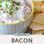 A savory bowl of bacon onion dip topped with fresh green onions, paired perfectly with a side of crispy ridged potato chips.