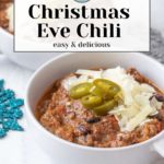 Two white bowls of beef chili topped with sliced jalapeños and shredded cheese, with text overlay "Christmas Eve Chili easy & delicious.