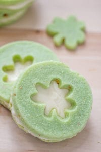 stacked pistachio pudding cookies sandwiched with buttercream