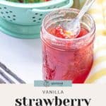 A jar of strawberry vanilla jam with a spoon beside a colander filled with strawberries. Text reads: "Vanilla strawberry jam recipe.