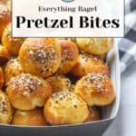 A tray of savory everything bagel pretzel bites topped with seeds rests invitingly on a white and black checkered cloth.