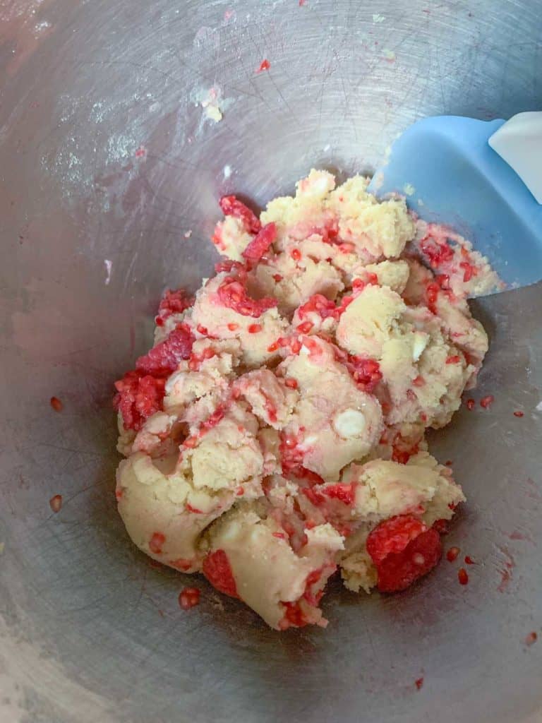 raspberries being added to cookie dough