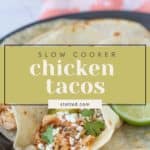 A plate of slow cooker chicken tacos with shredded chicken, cilantro, and crumbled cheese, garnished with a lime wedge. Text overlay reads "Delicious Slow Cooker Chicken Tacos.