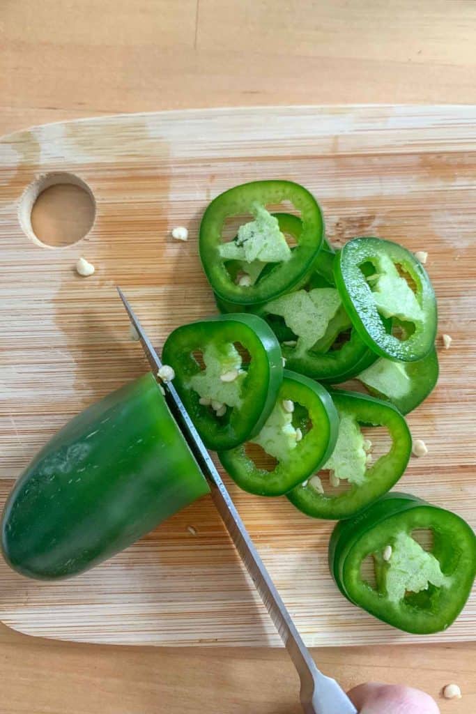 slicing jalapenos into rounds