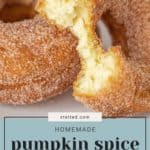 Close-up of homemade pumpkin donuts with a bitten piece exposing the interior texture. Text overlay reads, "stetted.com Homemade Pumpkin Spice Donuts.