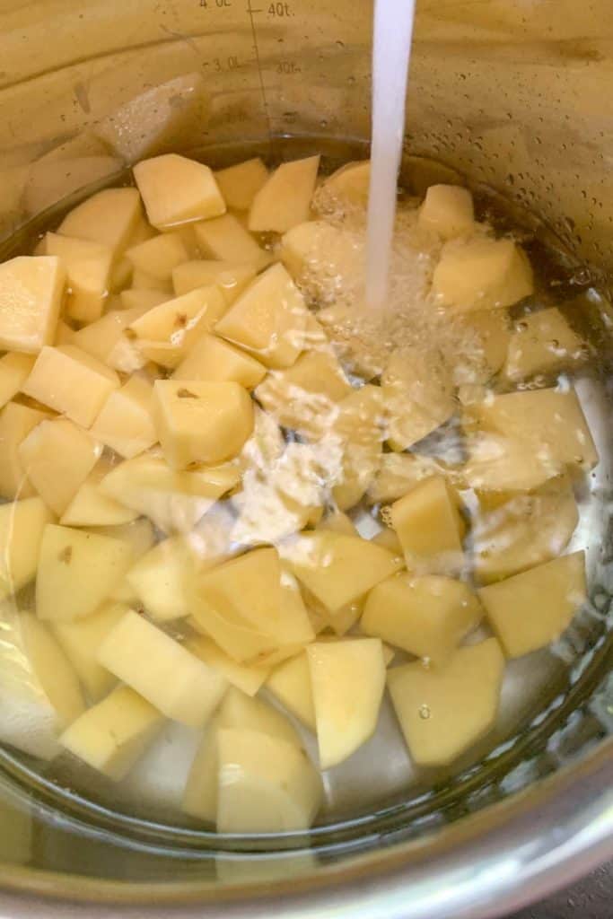 filling pot of potatoes with water