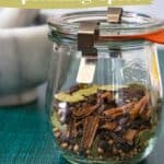 A glass jar filled with homemade pickling spice, containing various herbs and spices. The jar has a metal clamp lid. Text reads "homemade pickling spice" and "made from pantry ingredients.