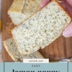 A hand delicately holds a slice of mouthwatering lemon poppy seed bread, resting beside the freshly baked loaf on a rustic wooden board. Text reads, "Easy lemon poppy seed bread.