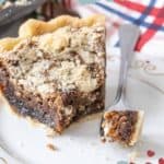 A slice of shoofly pie on a white plate with a fork holding a bite-sized piece. The pie has a crumbly topping and a dark, moist interior. A striped napkin is visible in the background. Text reads "Molasses Shoofly Pie" and "stetted.com.