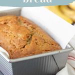 A loaf of banana bread in a metal pan lined with parchment paper showcases its delicious aroma. Above, the words "super moist banana bread recipe" draw you in, while a website link below invites you to discover more.