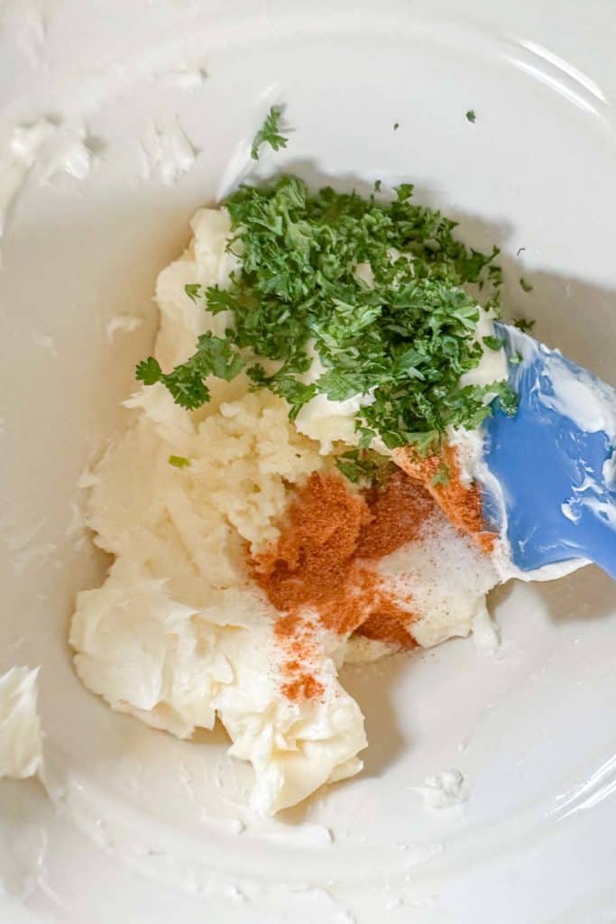 Ingredients for garlic butter in a bowl before mixing.