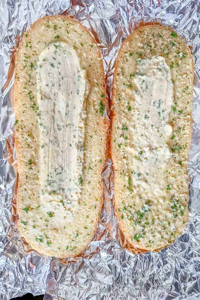 Parbaked garlic bread on foil.