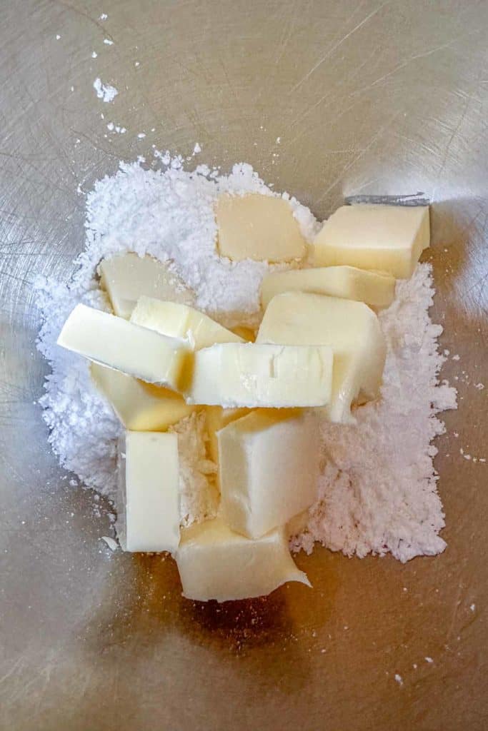 Butter and powdered sugar in a mixing bowl.