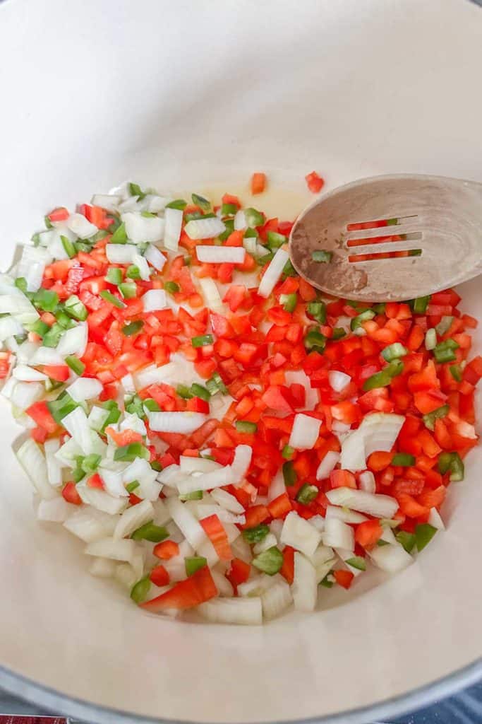 Sauteeing onions and peppers in a dutch oven.