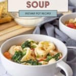 Savor hearty tortellini soup brimming with greens and tomatoes, perfectly complemented by fresh bread on the side.