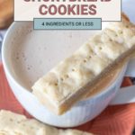 A mug of creamy drink with two rectangular shortbread cookies on a pink plate. Text overlay reads: "Easy Shortbread Cookies, 4 Ingredients or Less.