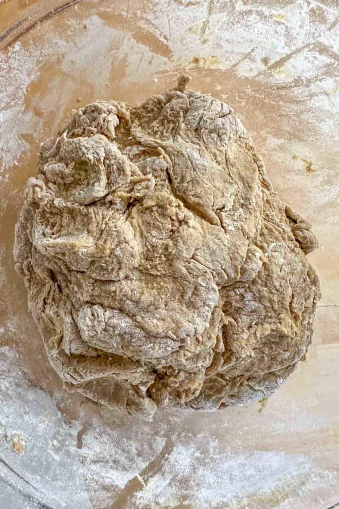 Mixed limpa bread dough in glass mixing bowl.