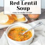 A bowl of steaming red lentil soup sits invitingly with a spoon on a soft cloth. In the background, slices of bread and a container of lentils complete the scene. Text on image: "Red Lentil Soup, easy to make recipe.