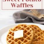 A plate of sweet potato waffles topped with a pat of butter and syrup on a white table with a fork and napkin in the background. Text reads: "Low Carb Recipe - Sweet Potato Waffles. For more tips, including how to freeze tomatoes, visit our blog.