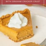 A slice of delicious pumpkin pie with a graham cracker crust topped with whipped cream on a white plate, with a fork holding a piece. Text overlay reads "pumpkin pie with graham cracker crust.